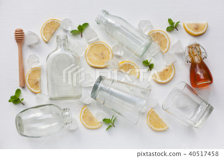 Glasses and bottle for drinks with lemon. Glasses and bottle for drinks with lemon. 40517458