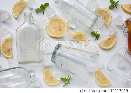 Glasses and bottle for drinks with lemon. Glasses and bottle for drinks with lemon. 40517459