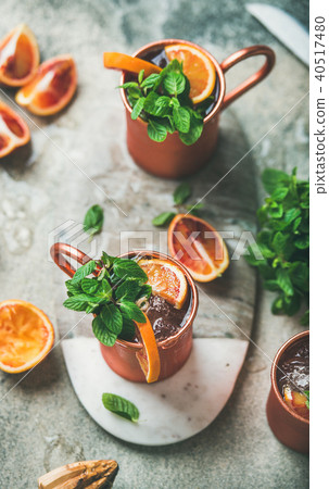 Blood orange Moscow mule alcohol cocktails in metal mugs Blood orange Moscow mule alcohol cocktails in metal mugs 40517480