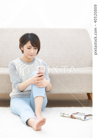 A Japanese woman watching a smartphone A Japanese woman watching a smartphone 40520809