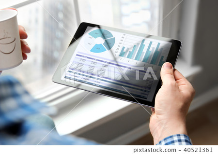 Business man working, analyzing financial graphs Business man working, analyzing financial graphs 40521361