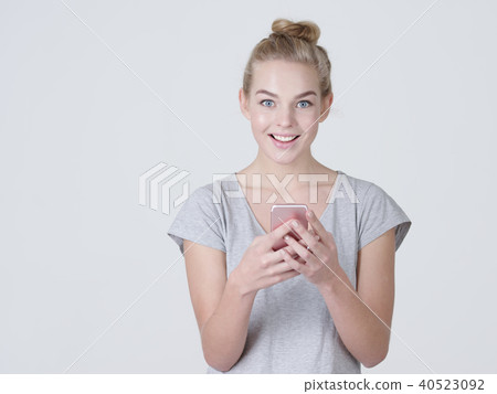woman is typing text message on mobile phone woman is typing text message on mobile phone 40523092
