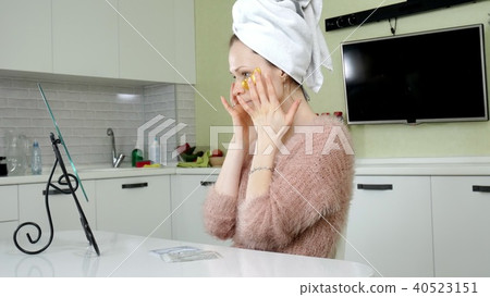 attractive woman spplying cosmetic facial patches at home attractive woman spplying cosmetic facial patches at home 40523151