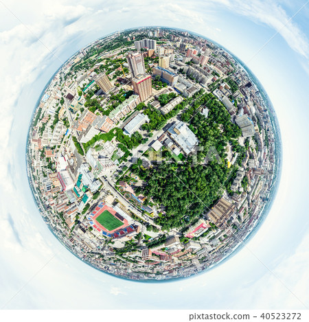 Aerial city view with crossroads and roads, houses, buildings, parks and parking lots. Sunny summer 40523272