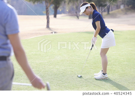 Men and women playing golf Men and women playing golf 40524345