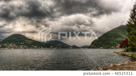 Clouds over the mountains and Lugano lake Clouds over the mountains and Lugano lake 40525311