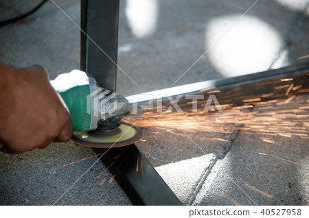 The worker is welding metal part of table steel. 40527958