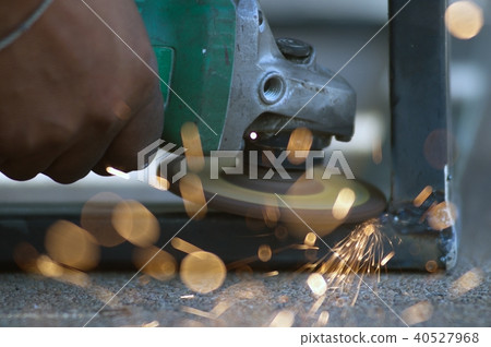 The worker is welding metal part of table steel. 40527968