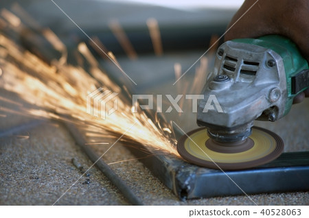 The worker is welding metal part of table steel. The worker is welding metal part of table steel. 40528063