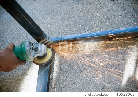 The worker is welding metal part of table steel. The worker is welding metal part of table steel. 40528065