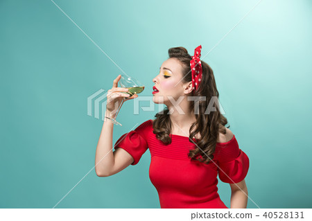 Beautiful young woman with pinup make-up and hairstyle. Studio shot on white background 40528131