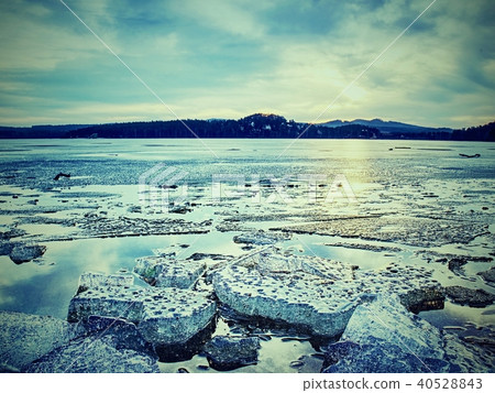 Melting of glaciers on stony shore. Fading floes 40528843
