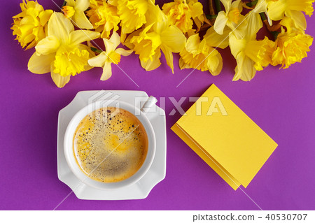 Table set with cup of coffee and narcissus flowers 40530707