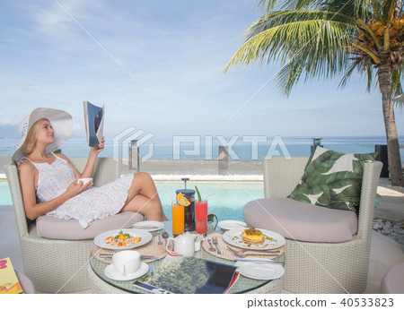 Woman relaxing sea view with morning coffee Woman relaxing sea view with morning coffee 40533823