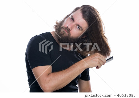 Man combs his hair with comb brush isolated  40535083