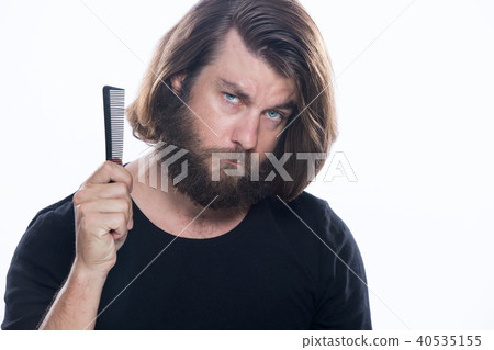 Man combs his hair with comb brush isolated white 40535155