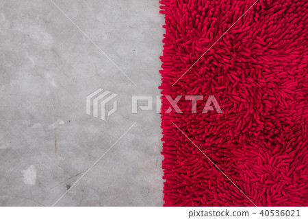 Gray concrete floor with red rug fluffy carpet 40536021