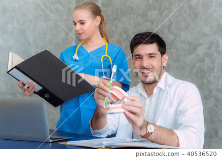 Dentist doctor with toothbrush and jaws. Dentist doctor with toothbrush and jaws. 40536520