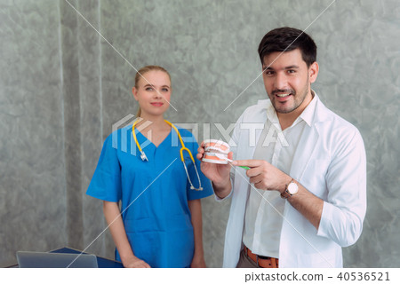 Dentist doctor with toothbrush and jaws. 40536521