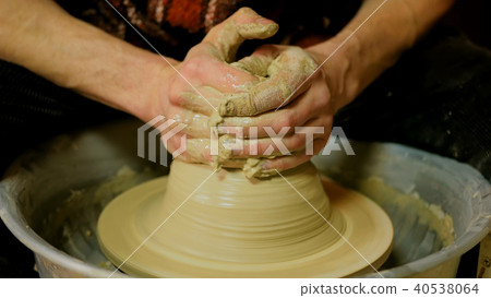 Professional male potter working with clay on potter's wheel Professional male potter working with clay on potter's wheel 40538064