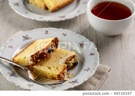 sliced cake with almonds and blueberries 40538347