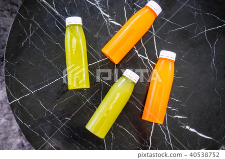 Bottles of cold-pressed juices on marble table Bottles of cold-pressed juices on marble table 40538752
