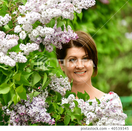 Smiling woman in alilac garden 40539345