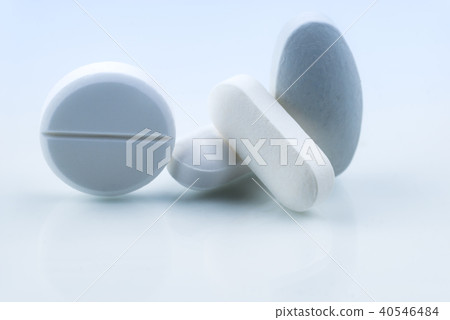 Pile of white tablet pills isolated on white  40546484