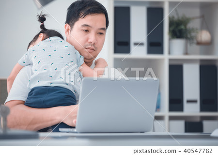 Asian family and little girl ,while dad works with notebook on w 40547782