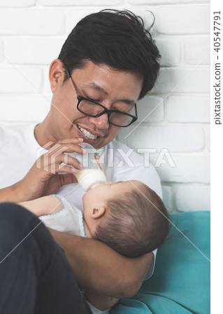 Nice moment. Agreeable young asian father holding his baby and s Nice moment. Agreeable young asian father holding his baby and s 40547791