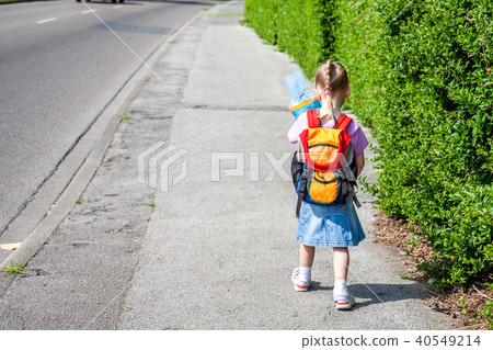 Little girl on her way to her first day of school Little girl on her way to her first day of school 40549214