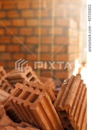 Pile of red clay bricks in construction site Pile of red clay bricks in construction site 40550802