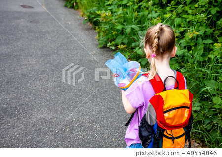Little girl on her way to her first day of school Little girl on her way to her first day of school 40554046