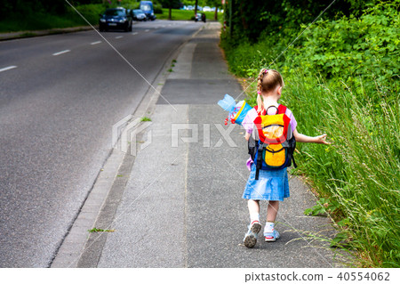 Little girl on her way to her first day of school Little girl on her way to her first day of school 40554062