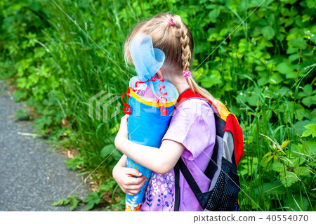 Little girl on her way to her first day of school Little girl on her way to her first day of school 40554070