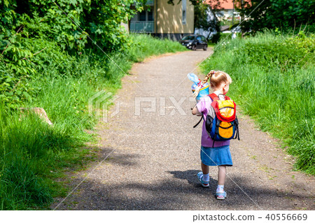 Little girl on her way to her first day of school Little girl on her way to her first day of school 40556669