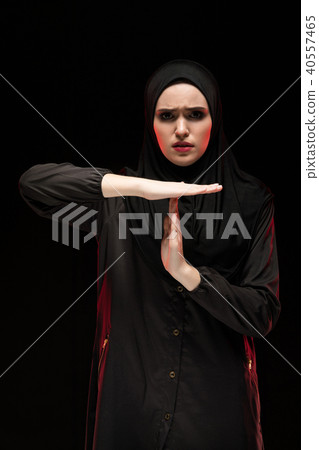 Portrait of beautiful desperate scared frightened young muslim woman wearing black hijab showing Portrait of beautiful desperate scared frightened young muslim woman wearing black hijab showing 40557465