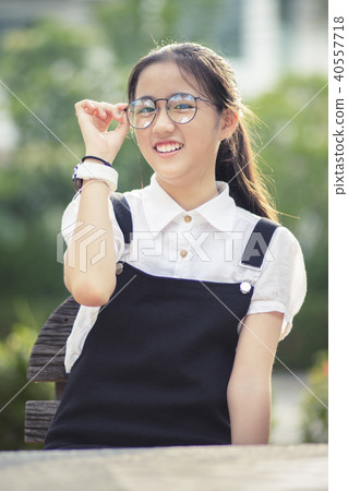 cheerful asian teenager wearing eyes glasses  40557718