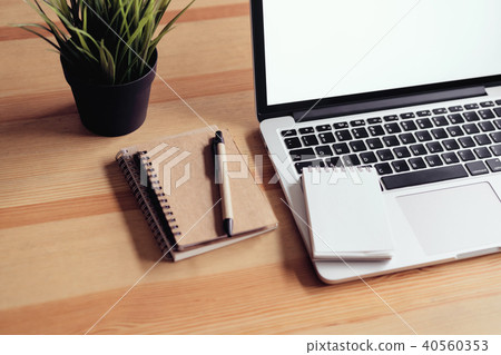 Laptop on table in the office room background. 40560353