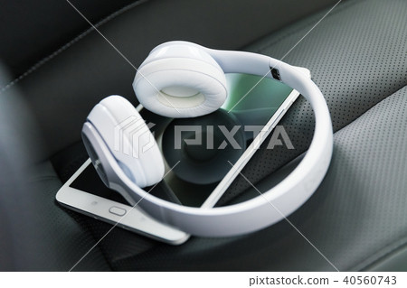 Headphones and tablet computer on the car seat 40560743