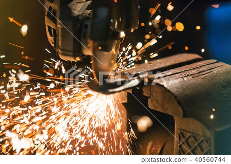 Metal grinder with sparkles in workshop Metal grinder with sparkles in workshop 40560744