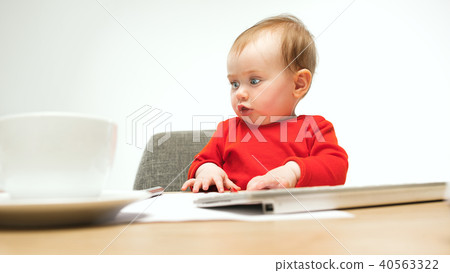 Happy child baby girl toddler sitting with keyboard of computer isolated on a white background Happy child baby girl toddler sitting with keyboard of computer isolated on a white background 40563322