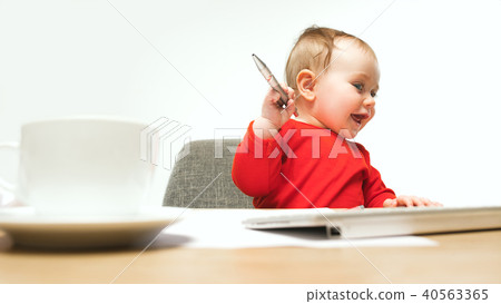 Happy child baby girl toddler sitting with keyboard of computer isolated on a white background 40563365