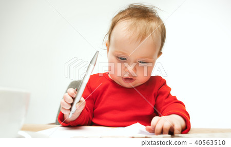 Happy child baby girl toddler sitting with keyboard of computer isolated on a white background 40563510
