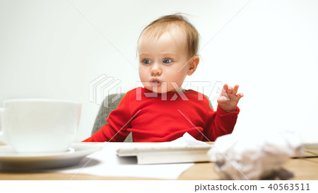 Happy child baby girl toddler sitting with keyboard of computer isolated on a white background Happy child baby girl toddler sitting with keyboard of computer isolated on a white background 40563511