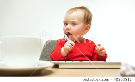Happy child baby girl toddler sitting with keyboard of computer isolated on a white background Happy child baby girl toddler sitting with keyboard of computer isolated on a white background 40563512