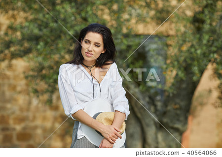 Smiling summer woman with sunglasses in italian garden Smiling summer woman with sunglasses in italian garden 40564066
