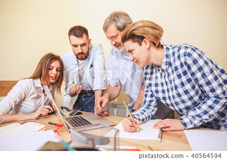 Team job. Photo young businessmans working with new project in office Team job. Photo young businessmans working with new project in office 40564594