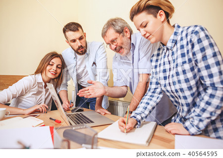 Team job. Photo young businessmans working with new project in office Team job. Photo young businessmans working with new project in office 40564595