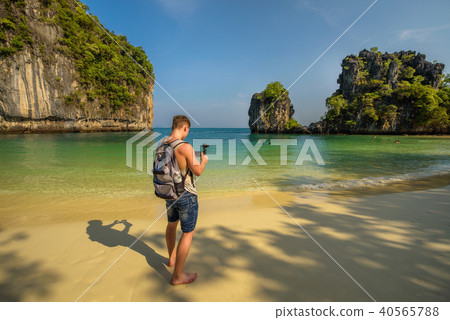 Young boy films the beach on the Koh Hong island in Thailand 40565788